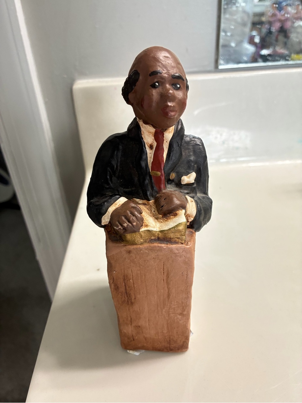 Vintage African American preacher or minister figurine standing at a pulpit